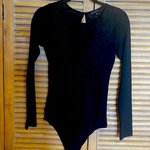Sheer appliquéd bodysuit.  Stretch. Says large runs small. Like new.